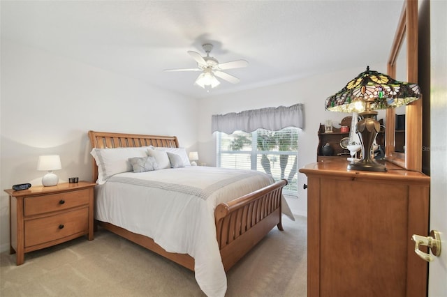 bedroom with light carpet and ceiling fan