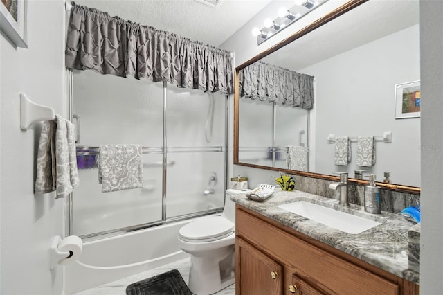 full bathroom with vanity, a textured ceiling, shower / bath combination with glass door, and toilet