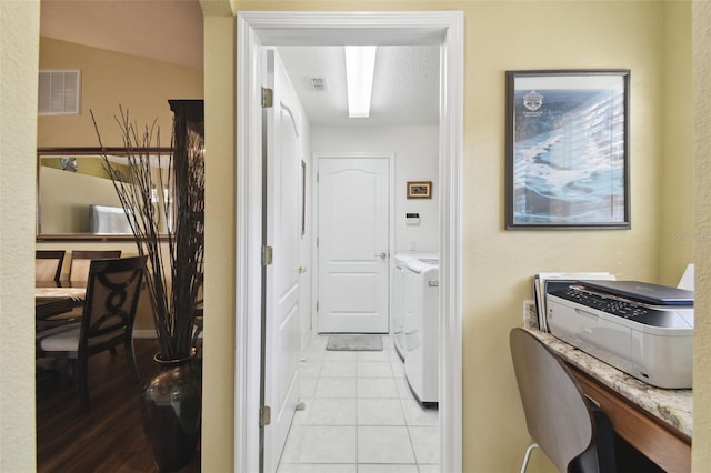 laundry room with light tile patterned floors and washer and dryer