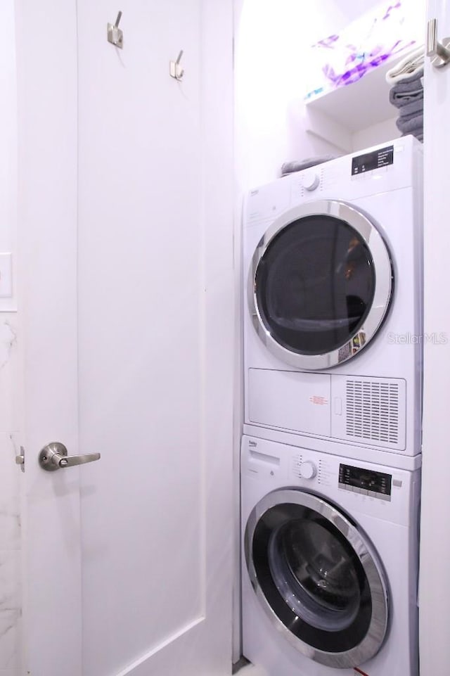 washroom featuring stacked washer / dryer