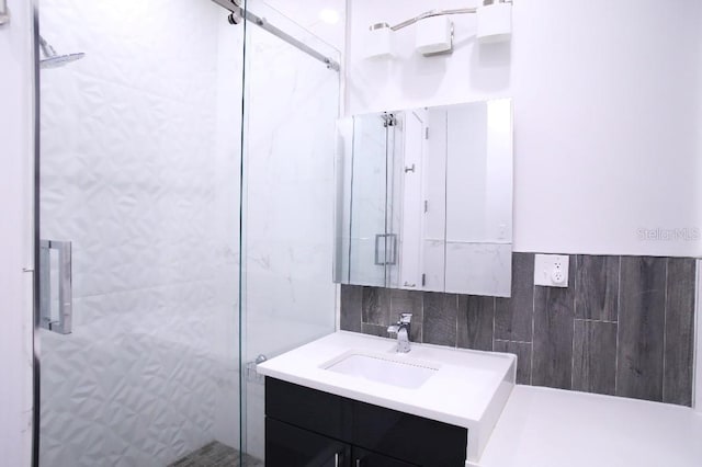 bathroom featuring vanity, tile walls, and walk in shower