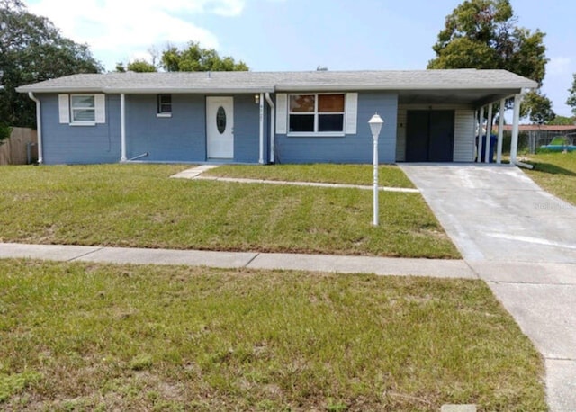 ranch-style house with a carport and a front lawn