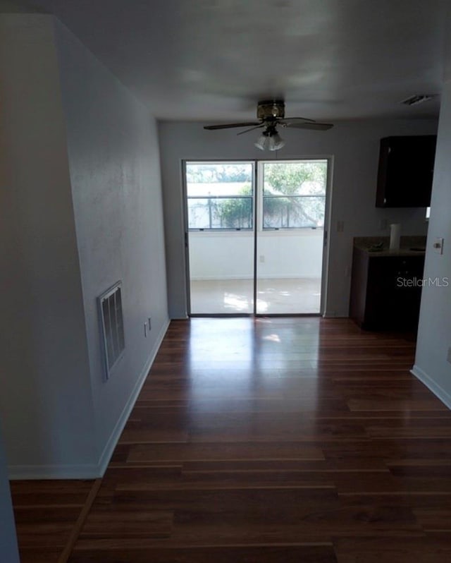 interior space with ceiling fan and dark hardwood / wood-style floors