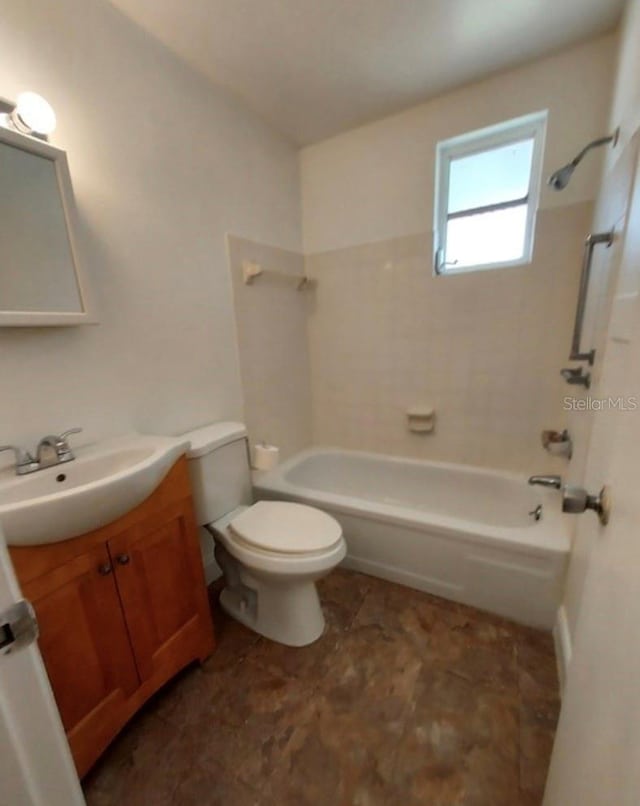 full bathroom with vanity, toilet, and tiled shower / bath combo