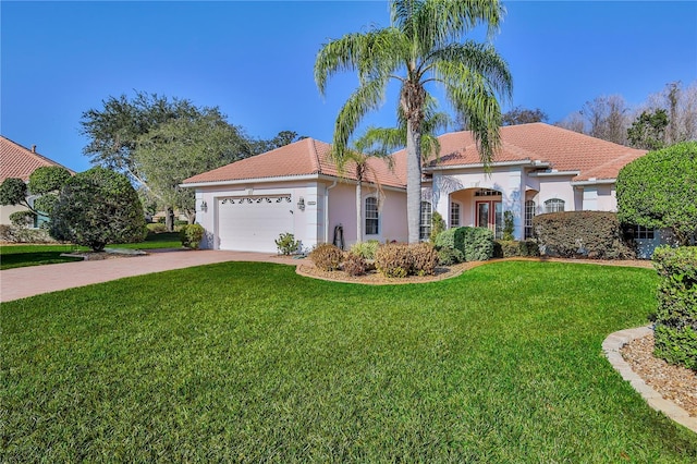 mediterranean / spanish-style home with a garage and a front yard