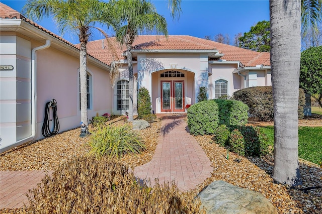 view of exterior entry featuring french doors