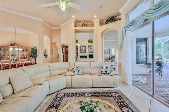 tiled living room featuring crown molding and ceiling fan with notable chandelier