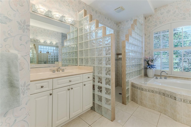 bathroom featuring vanity, shower with separate bathtub, and tile patterned floors