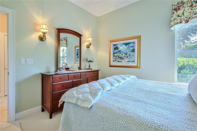 bedroom featuring multiple windows, ornamental molding, and light colored carpet