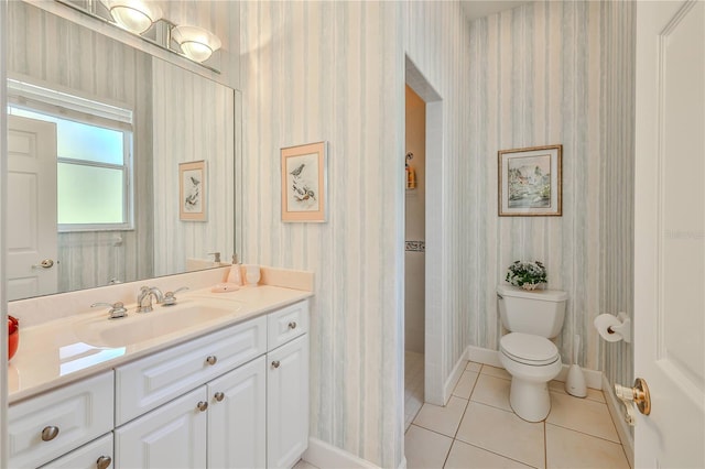 bathroom with tile patterned floors, toilet, vanity, and a shower