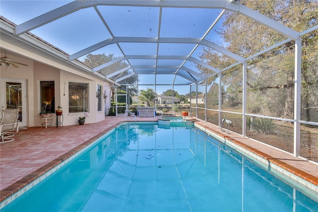 view of pool featuring a lanai, a patio, and an in ground hot tub