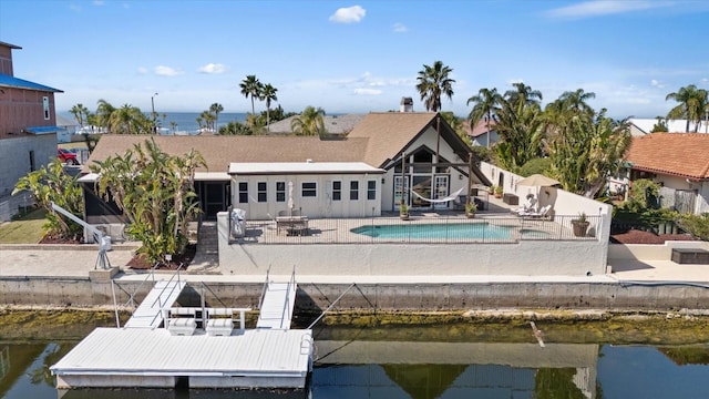 back of house featuring a patio and a water view