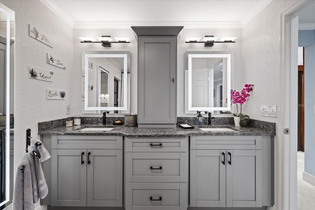 bathroom with ornamental molding and vanity