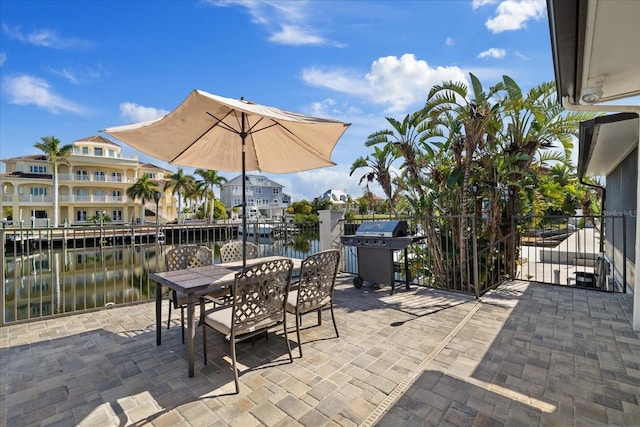 view of patio with a water view and grilling area