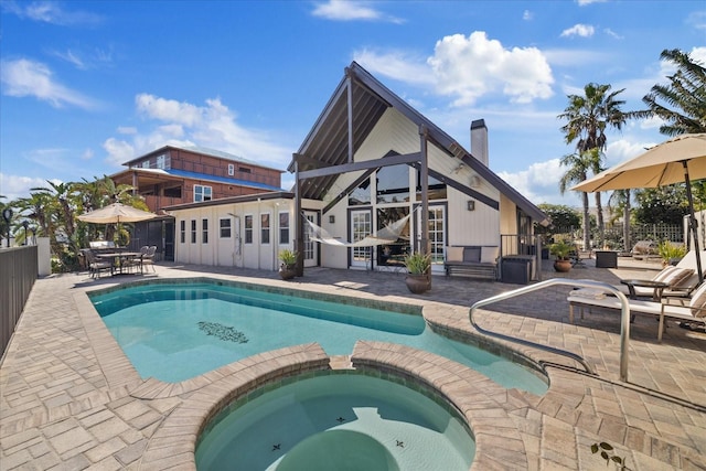 view of pool with a patio area and an in ground hot tub