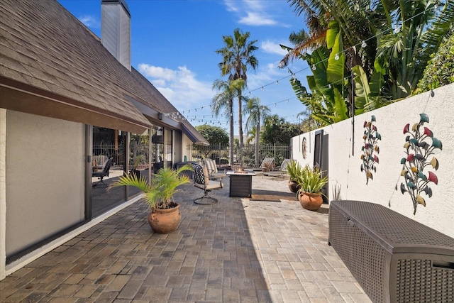 view of patio / terrace featuring central air condition unit and a fire pit