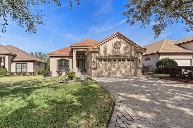 mediterranean / spanish home with a garage and a front yard