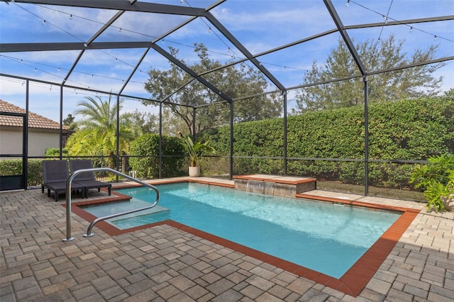 view of swimming pool with a jacuzzi, a patio, pool water feature, and a lanai