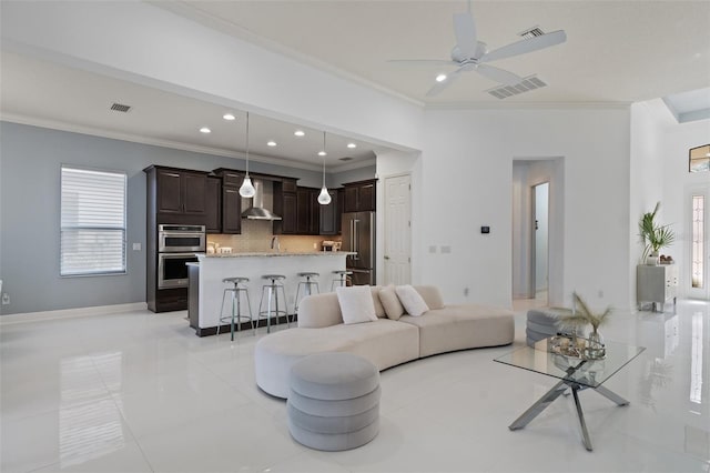 living room featuring crown molding, ceiling fan, light tile patterned flooring, and sink