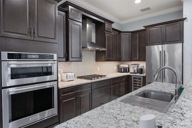 kitchen with wine cooler, wall chimney exhaust hood, dark brown cabinetry, tasteful backsplash, and stainless steel appliances