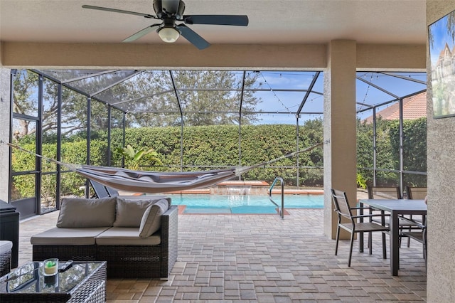 exterior space featuring an outdoor living space, ceiling fan, and glass enclosure