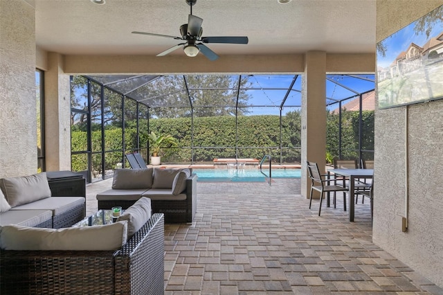 view of patio with a lanai, an outdoor hangout area, and ceiling fan