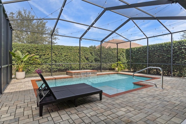 view of pool featuring pool water feature, a lanai, a jacuzzi, and a patio area