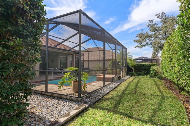 exterior space featuring a lanai, a patio area, and a lawn