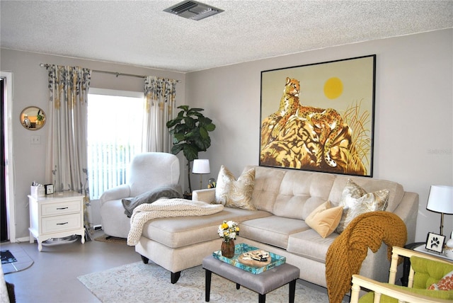 living room featuring concrete floors and a textured ceiling