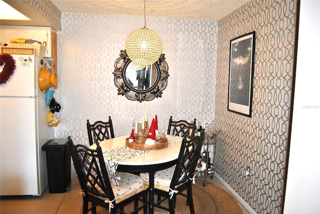 dining area featuring tile patterned floors and a textured ceiling