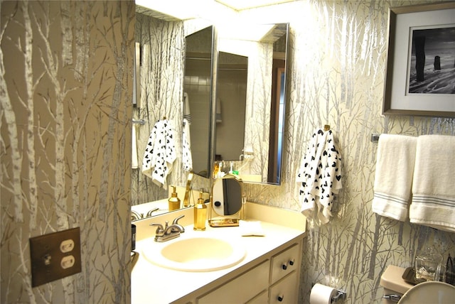 bathroom featuring vanity and toilet