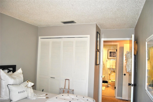 bedroom with a closet and a textured ceiling