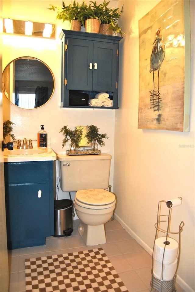 bathroom featuring vanity, tile patterned floors, and toilet