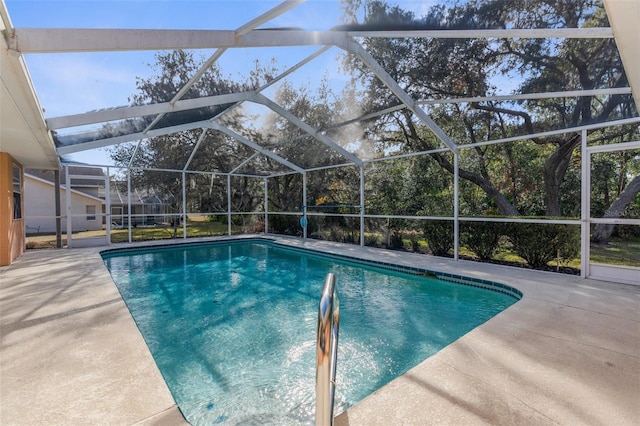 view of swimming pool featuring a lanai and a patio area