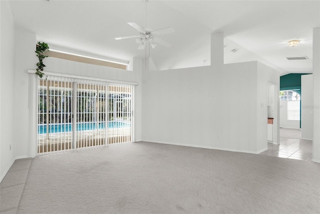 empty room with light carpet, lofted ceiling, and ceiling fan