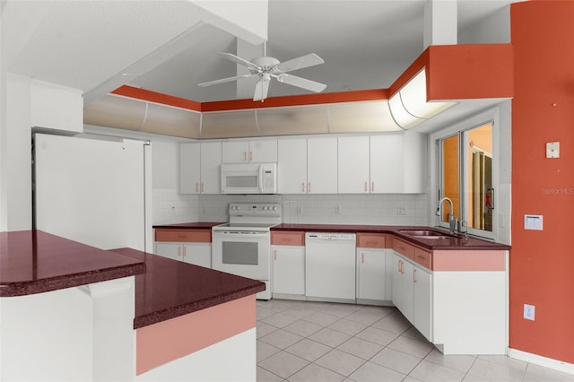 kitchen featuring sink, white appliances, and white cabinets