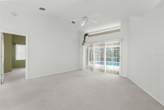 carpeted spare room with lofted ceiling, a wealth of natural light, and ceiling fan