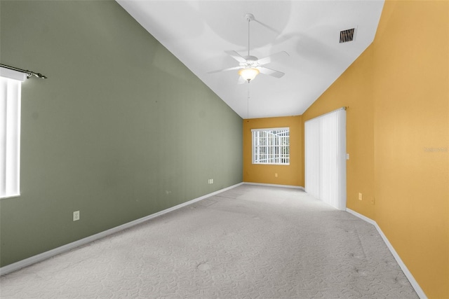 carpeted spare room with high vaulted ceiling and ceiling fan