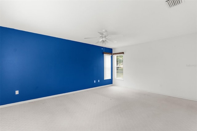 spare room featuring ceiling fan and carpet flooring