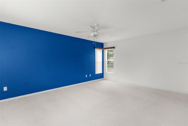 carpeted empty room featuring ceiling fan