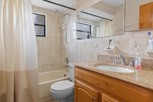 full bathroom with tasteful backsplash, tile walls, vanity, toilet, and shower / bath combo