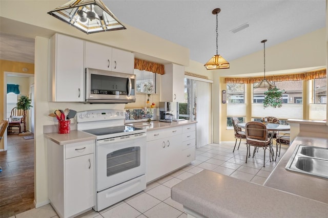 kitchen featuring decorative light fixtures, white cabinetry, lofted ceiling, light tile patterned floors, and white range with electric cooktop