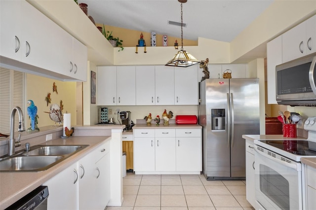 kitchen with sink, hanging light fixtures, stainless steel appliances, white cabinets, and light tile patterned flooring