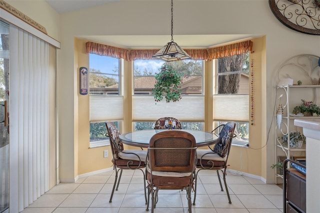 dining room featuring light tile patterned floors and a healthy amount of sunlight