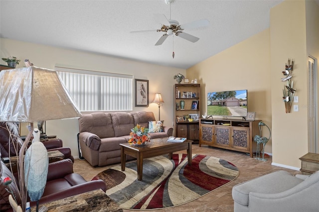 living room featuring ceiling fan, vaulted ceiling, and a textured ceiling