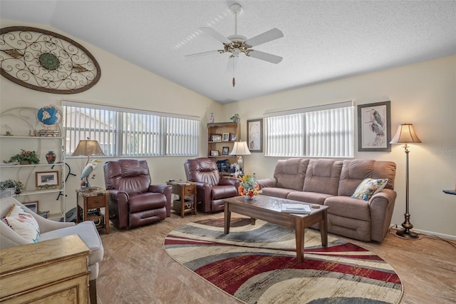 living room featuring ceiling fan, lofted ceiling, and a textured ceiling