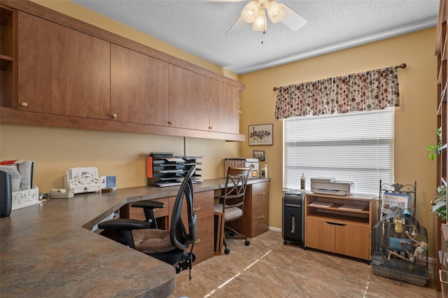 office space featuring ceiling fan and a textured ceiling