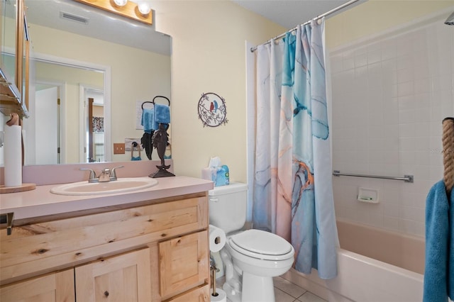 full bathroom with shower / tub combo with curtain, tile patterned floors, toilet, and vanity