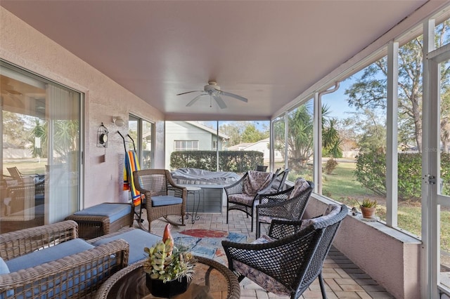 sunroom / solarium featuring ceiling fan