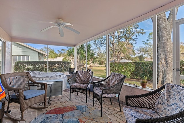 sunroom featuring ceiling fan